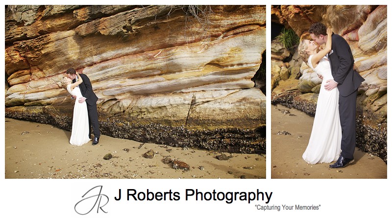 Couple kissing with orange sandstone rock face behind - wedding photography sydney